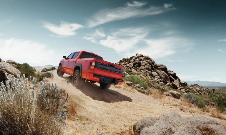 2025 Nissan Frontier offroading up a hill