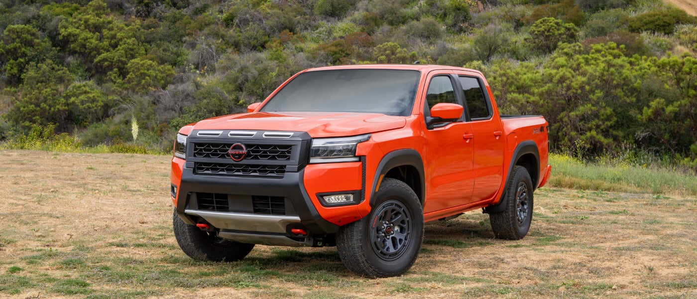2025 Nissan Frontier parked by grassy hill