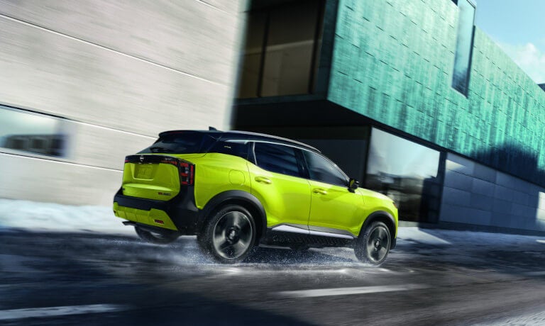 2025 Nissan Kicks driving on wet road