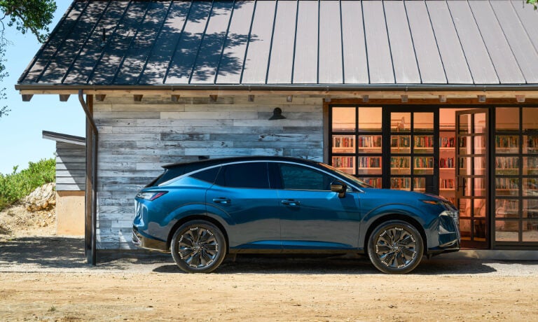 2025 Nissan Murano parked by a house with books