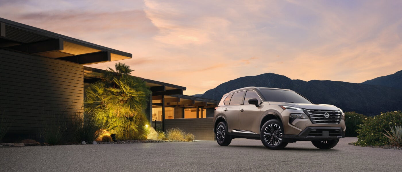 2025 Nissan Rogue parked by a home at sunset