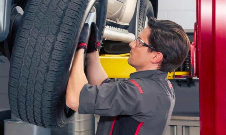 Kia technician working on wheel