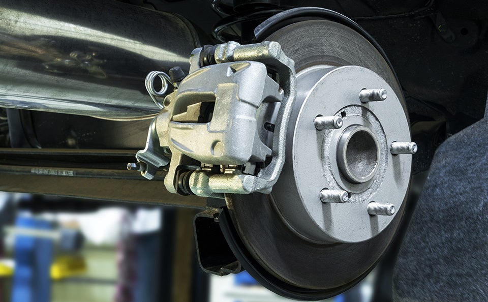 Close-up of a vehicle brake rotor and caliper assembly.